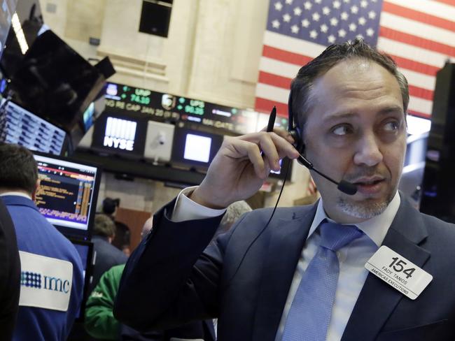 Trader Fady Tanois works on the floor of the New York Stock Exchange, Wednesday, Jan. 20, 2016. Energy stocks are leading another sell-off on Wall Street as the price of oil continues to plunge. (AP Photo/Richard Drew)