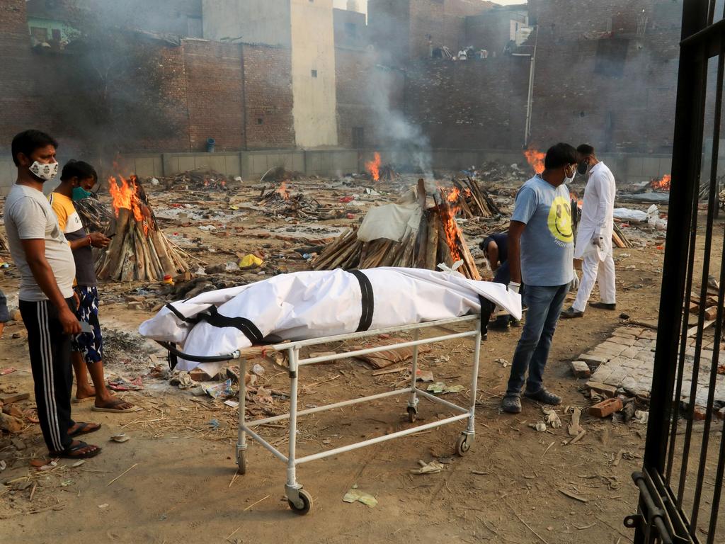 Family members carry a body of their relative who died from coronavirus for cremation at a crematorium in India. Picture: Naveen Sharma/Getty Images