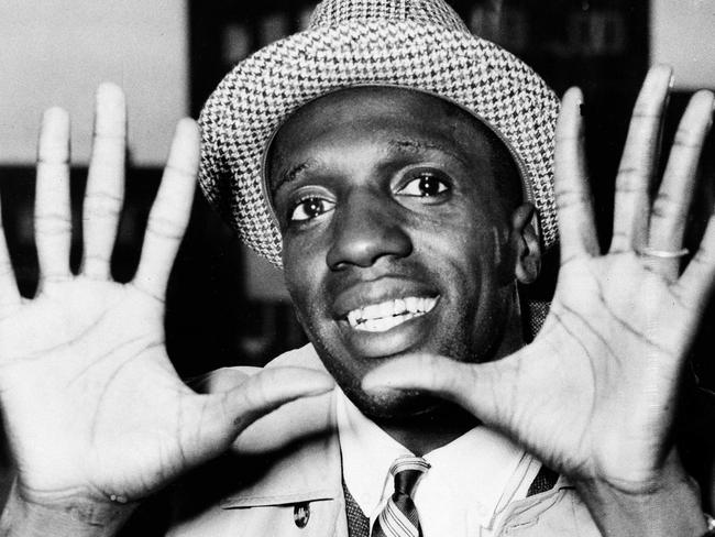 FILE - In this May 17, 1959, file photo, Meadowlark Lemon, of the Harlem Globetrotters, shows off his large hands on arrival in London where the team was to perform at the Empire Pool in Wembley for a week. Lemon, known as the Globetrotters' "clown prince" of basketball, died Sunday, Dec. 27, 2015, in Scottsdale, Ariz. He was 83. (AP Photo/File)