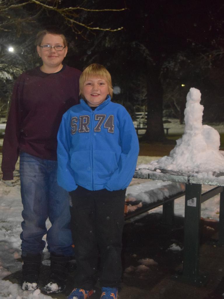 Christopher and Taylor Unold check out the snow in Weeroona Park. Photo: Alex Nolan / Stanthorpe Border Post