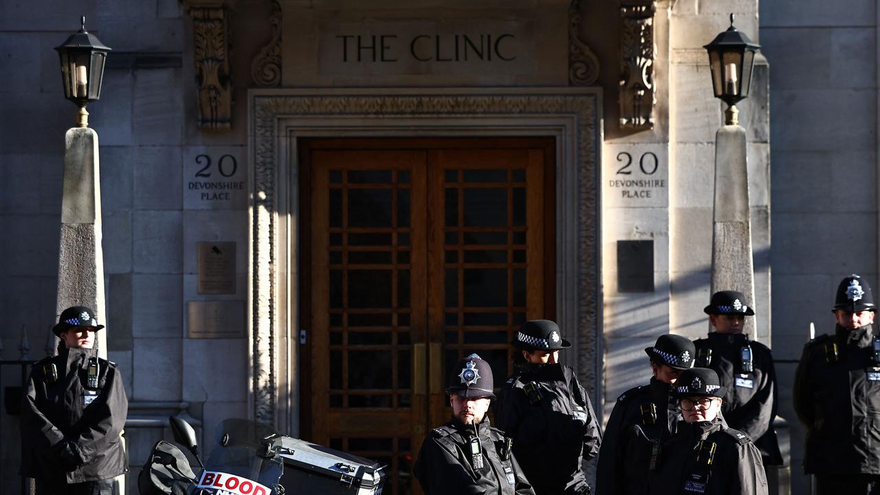 Police officers stand guard outside the entrance to London Clinic, where Kate was being treated. Picture: AFP