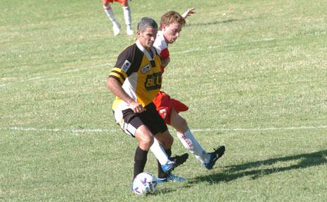 OLD HAND: Craig Foster, left, takes on a Workers opponent in the inaugural Corey New Cup match in 2007.