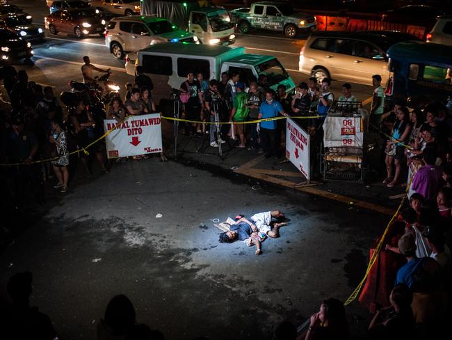 An alleged drug dealer and victim of a summary execution lies dead on a main thoroughfare on July 23, 2016 in Manila, Philippines. The victim was an alleged drug peddler, a claim disputed by his wife. Picture: Getty Images/Dondi Tawatao