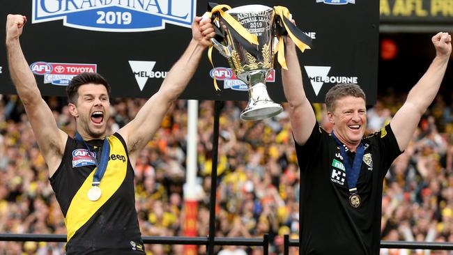 Captain Trent Cotchin and coach Damien Hardwick hold the 2019 premiership cut aloft. Picture: Michael Klein (AAP).