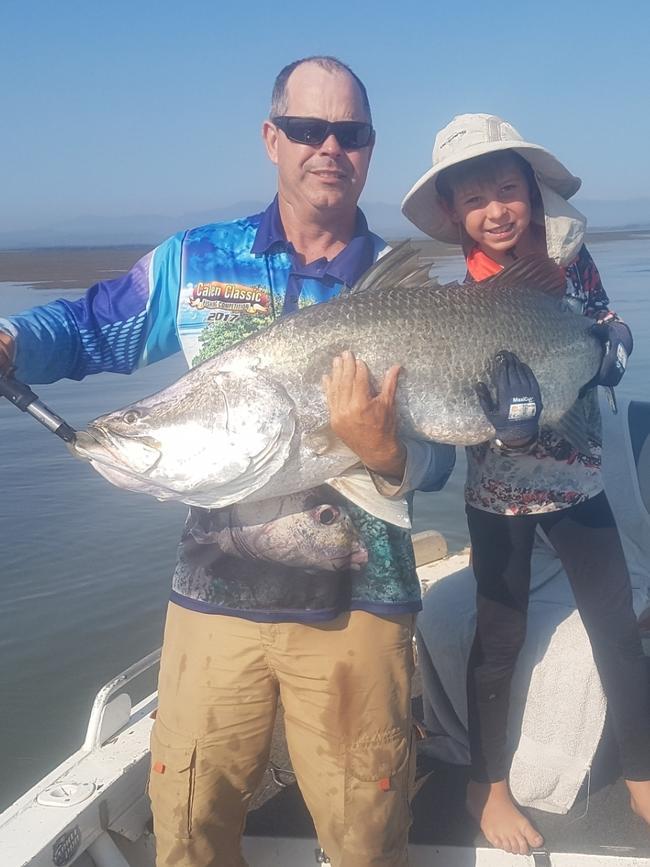 Mackay Recreational Fishers Alliance president John Bennett holding a massive barra with his son Jack Bennett.