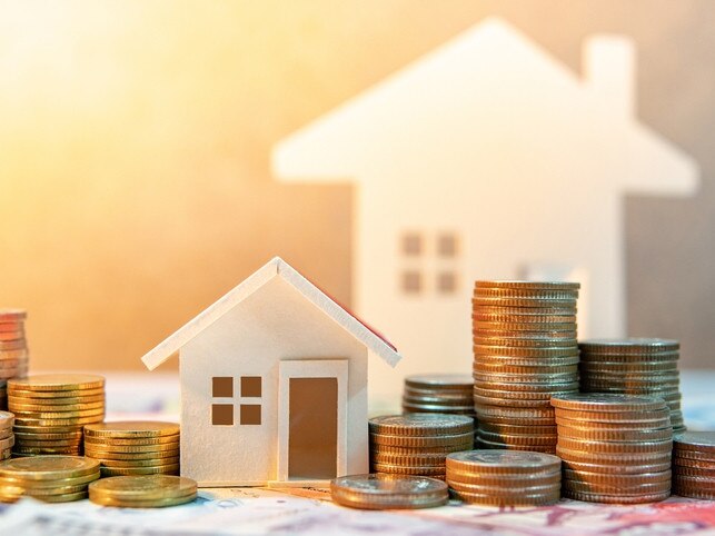 Real estate or property investment. Home mortgage loan rate. Saving money for retirement concept. Coin stack on international banknotes with house model on table. Business growth background Picture: iStock