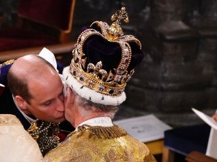 LONDON, ENGLAND - MAY 06: Prince William, Prince of Wales kisses his father, King Charles III, wearing St Edward's Crown, during the King's Coronation Ceremony inside Westminster Abbey on May 6, 2023 in London, England. The Coronation of Charles III and his wife, Camilla, as King and Queen of the United Kingdom of Great Britain and Northern Ireland, and the other Commonwealth realms takes place at Westminster Abbey today. Charles acceded to the throne on 8 September 2022, upon the death of his mother, Elizabeth II. (Photo by Yui Mok  - WPA Pool/Getty Images)