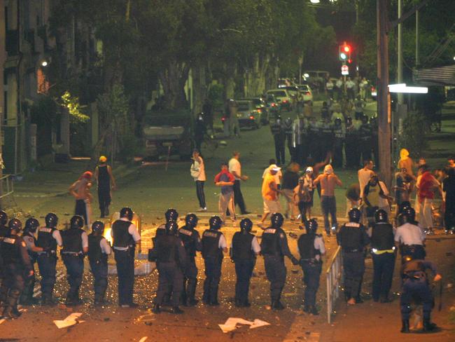 Riot police and firemen stand-off with locals after the death of teenager Thomas Hickey in Redfern in 2004. Picture: Bill Hearne