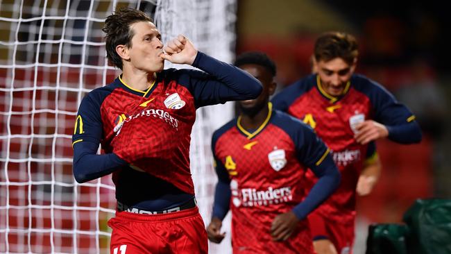 Adelaide United’s Craig Goodwin sends a message to his pregnant partner after scoring his team’s second goal at Coopers Stadium. Picture: Getty Images