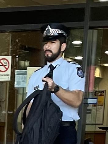 Queensland Police Service Senior Constable Renzo Martinez leave court after giving evidence at an inquest into a death in custody incident where a man died enroute to Rockhampton watch house in November 2019 after being arrested and restrained in the Leichhardt Hotel car park, on Bolsover Street, across the road from the police station and watch house.