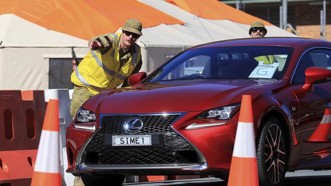 Members of the Australian Army assist Queensland police at the Miles St checkpoint. Picture: Scott Powick.