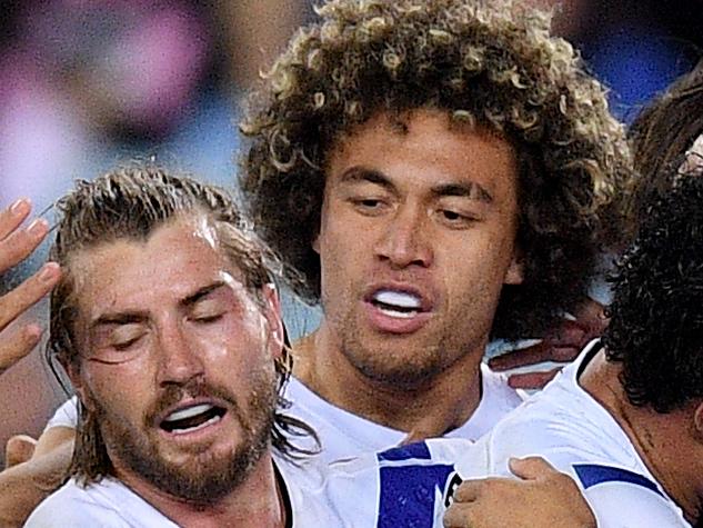 Corey Harawira-Naera of the Bulldogs (centre) celebrates with teammates after scoring a try during the Round 22 NRL match between the South Sydney Rabbitohs and the Canterbury Bulldogs at ANZ Stadium in Sydney, Saturday, August 17, 2019. (AAP Image/Dan Himbrechts) NO ARCHIVING, EDITORIAL USE ONLY