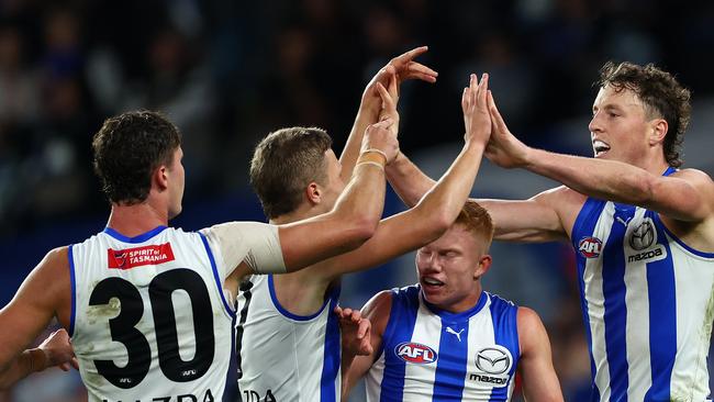 MELBOURNE, AUSTRALIA - APRIL 21: Nick Larkey of the Kangaroos is congratulated by team mates after kicking a goal during the round six AFL match between North Melbourne Kangaroos and Hawthorn Hawks at Marvel Stadium, on April 21, 2024, in Melbourne, Australia. (Photo by Quinn Rooney/Getty Images)