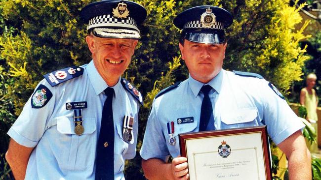 Senior Police Constable Stuart Allan (right)  awarded a Medal of Valour in 2002 by Police Commissioner Bob Atkinson.