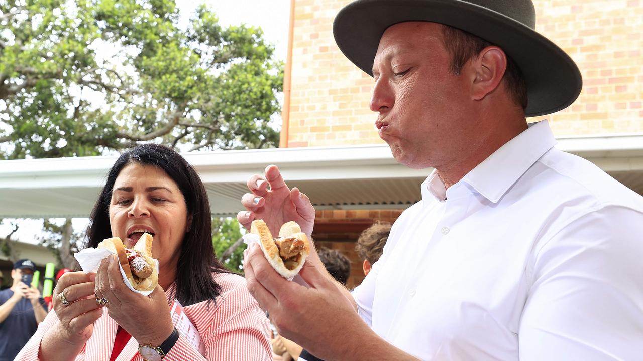 Steven Miles tries a snag for lunch with McConnel MP Grace Grace. Picture: Adam Head