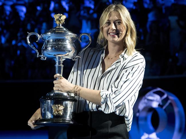 Maria Sharapova carried the Daphne Akhurst Memorial Cup on to Margaret Court Arena during the ceremony for the official draw at the Australian Open.