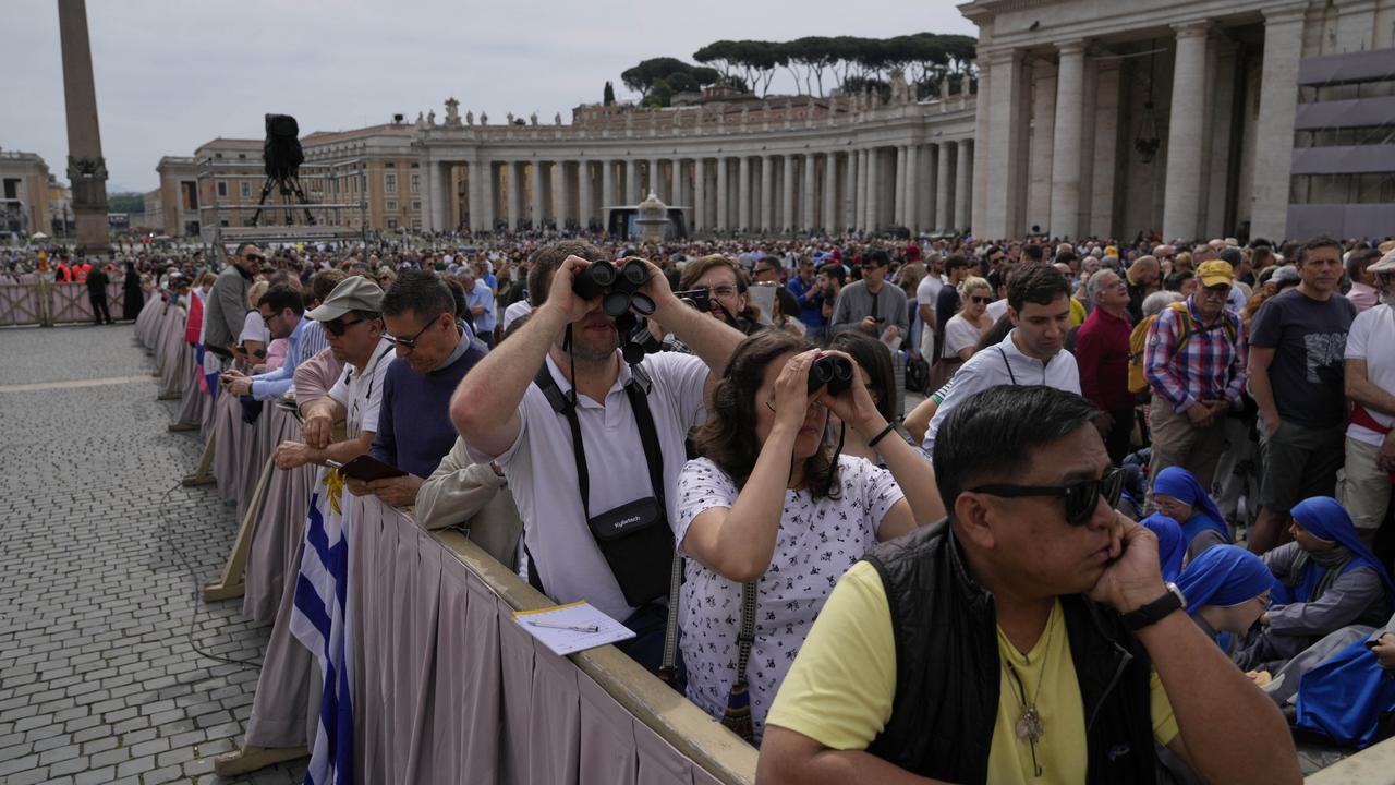 Faithful point their binoculars as they wait for Pope Leo XIV to appear at the central balcony of St. Peter's Basilica for his first Sunday blessing after his election. Picgure: AP Photo/Gregorio Borgia