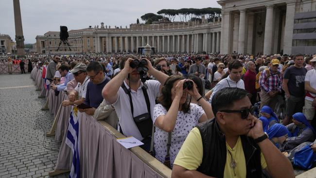 Faithful point their binoculars as they wait for Pope Leo XIV to appear at the central balcony of St. Peter's Basilica for his first Sunday blessing after his election. Picgure: AP Photo/Gregorio Borgia