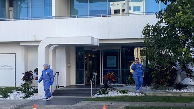 Police forensics officers at the front of the building. Photo: Jacob Miley