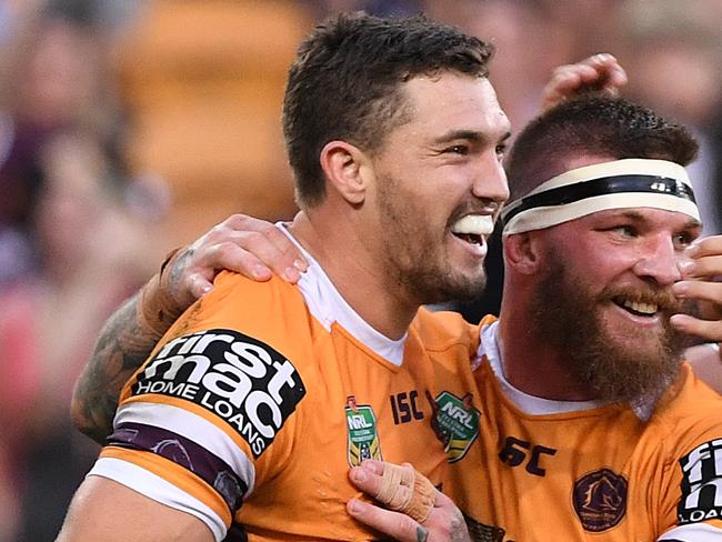 Corey Oates of the Broncos (left) celebrates with teammates after scoring a try during the Round 25 NRL match between the Brisbane Broncos and the Manly-Warringah Sea Eagles at Suncorp Stadium in Brisbane, Sunday, September 2, 2018. (AAP Image/Dave Hunt) NO ARCHIVING, EDITORIAL USE ONLY