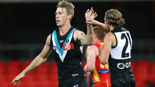 Todd Marshall celebrates with Xavier Duursma in the win over the Suns. Picture: Jono Searle/AFL Photos/Getty Images.