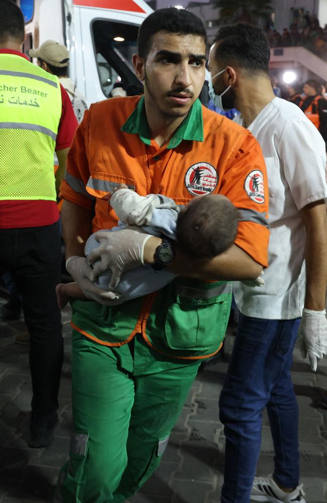 A medic transports an injured Palestinian baby into Al-Shifa hospital in Gaza City following an Israeli airstrike. Picture: AFP