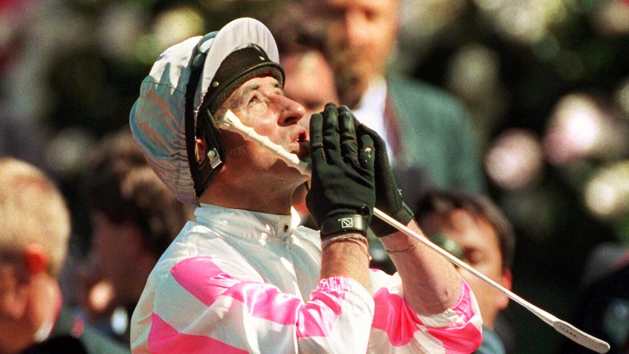 Jockey Jim Cassidy praying showing gratitude riding racehorse Might And Power back to scale after winning 1997 Melbourne Cup race. might/and/power /Horseracing/Melbourne/Cup