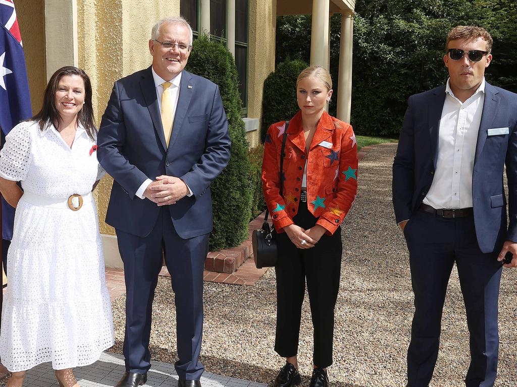 Grace Tame looks unimpressed standing next to the Prime Minister. Picture: NCA NewsWire / Gary Ramage