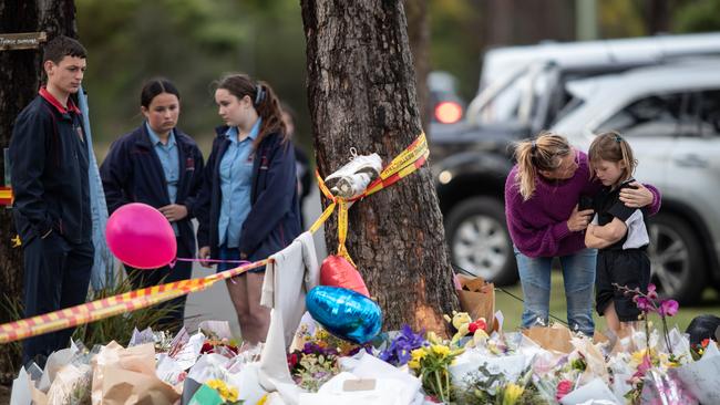 Mourners at the crash site. Picture: Julian Andrews