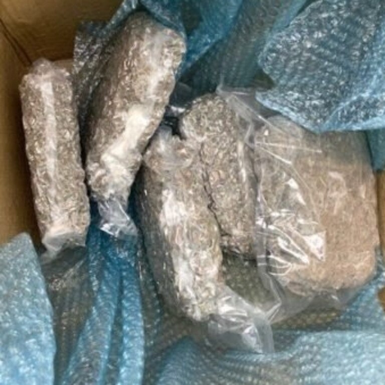 Police allege they located $56,000 cash inside a package on the roadside, as well as 2.4kg of cannabis in the boot. Picture: Queensland Police