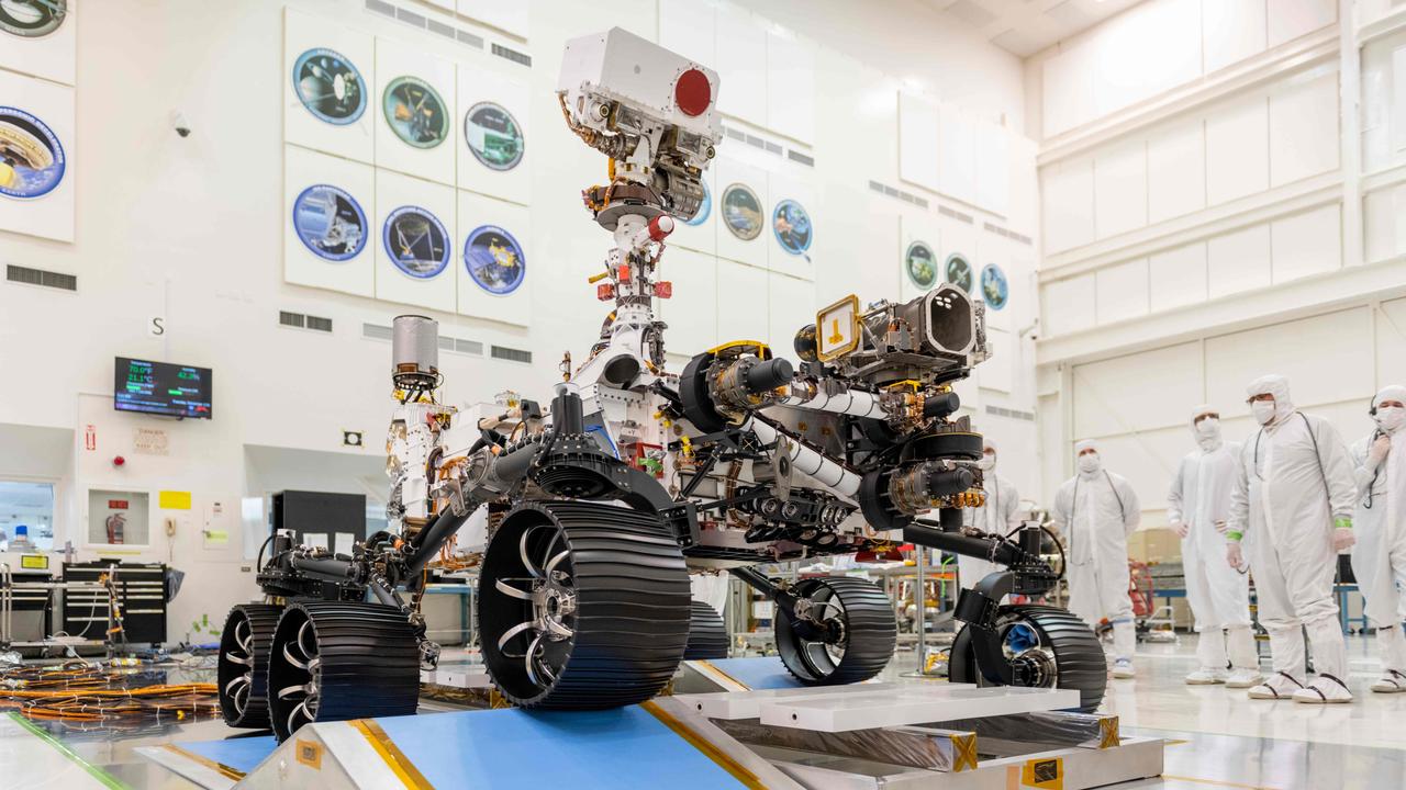 In this image obtained from NASA, engineers in a clean room at NASA's Jet Propulsion Laboratory in Pasadena, California, observe the first driving test for NASA's Perseverance rover on December 17, 2019. (Photo by – / NASA/JPL-CALTECH / AFP)