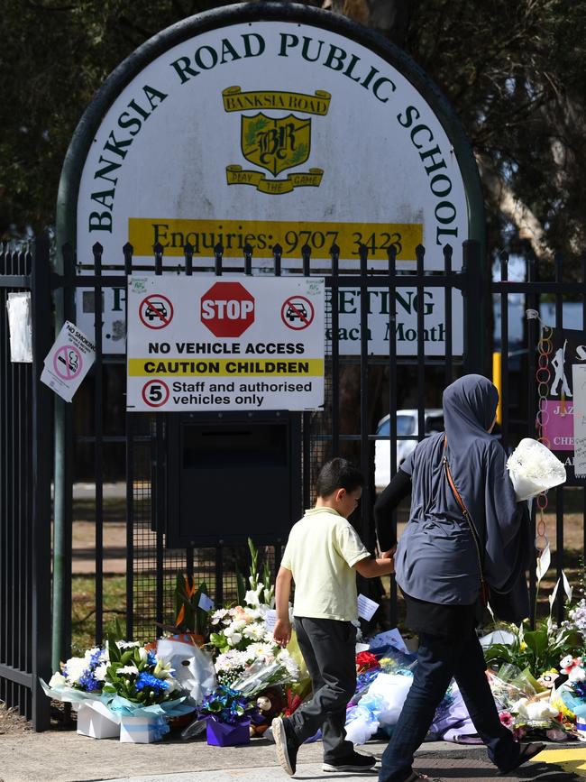 Tributes laid outside the main entrance to Banksia Road Public School in Greenacre in 2017 after the tragedy. Picture: AAP