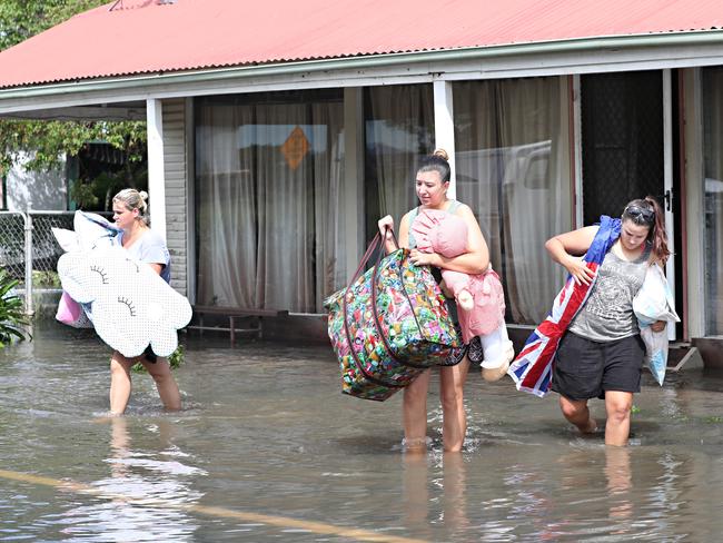 Felicity Allen, Ashley and Kristy Bourke evacuating their home in North Eton near Mackay. Picture: Annette Dew