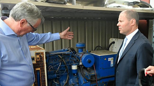 Andrew Ferguson, pictured with Environment and Energy Minister Josh Frydenberg MP and a 60kva diesel generator Mr Ferguson has bought for his plant. Picture: Roy Vandervegt