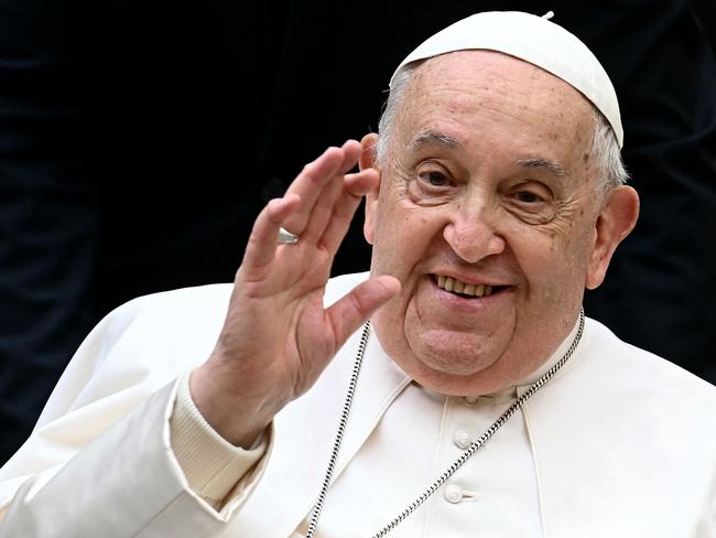 (FILES) Pope Francis waves as he arrives to attend the unveil of a new electric popemobile, at the Vatican on December 4, 2024. Pope Francis passed a 