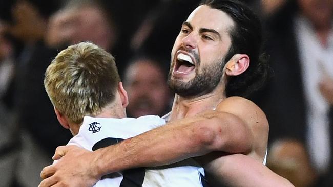 Brodie Grundy celebrates a goal with teammate Jordan De Goey, who is out of contract at the end of next year.