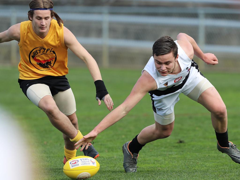 Under 16 Boys STJFL vs. NTJFA match, North Hobart Oval: North's Cooper Foot-Hill (right) reaches low for the ball. Picture: LUKE BOWDEN