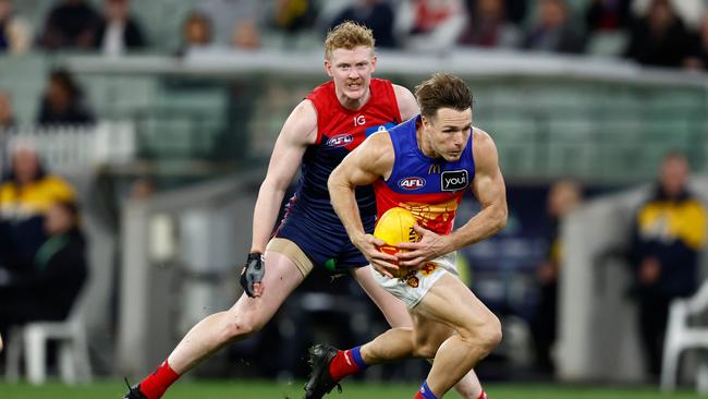 MELBOURNE, AUSTRALIA - APRIL 11: Lincoln McCarthy of the Lions and Clayton Oliver of the Demons compete for the ball during the 2024 AFL Round 05 match between the Melbourne Demons and the Brisbane Lions at the Melbourne Cricket Ground on April 11, 2024 in Melbourne, Australia. (Photo by Michael Willson/AFL Photos via Getty Images)