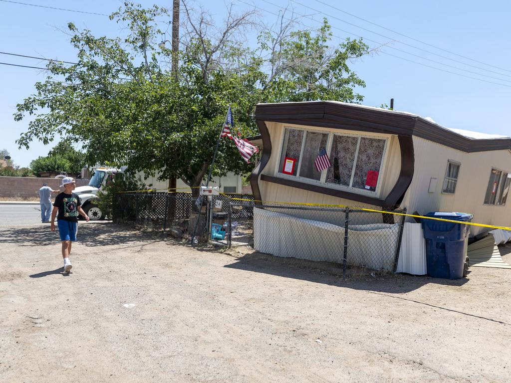 A child walks by one of the mobile homes knocked off its foundation by an earthquake in Ridgecrest on Friday. Picture: AP