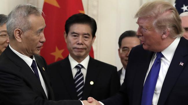 President Donald Trump shakes hands with Chinese Vice Premier Liu He after signing a trade agreement in the White House. Picture: AP