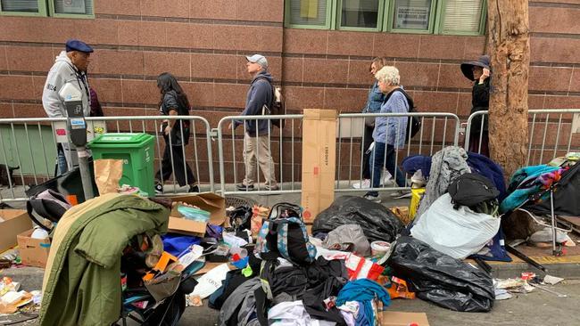 BEFORE: A homeless encampment on the street as tour participants of the "Celebrate Tenderloin Tour" walk through the Tenderloin District in San Francisco on Aug. 26, 2023. David G. McIntyre