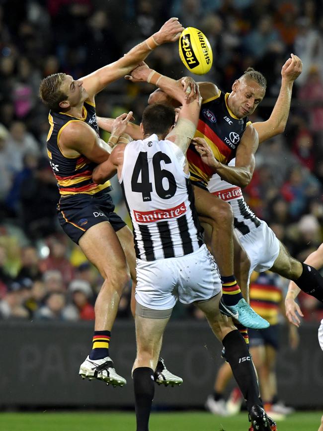 Daniel Talia and Cameron Ellis-Yolmen of the Crows spoil the ball from Mason Cox of the Magpies. Picture: AAP Image/Sam Wundke