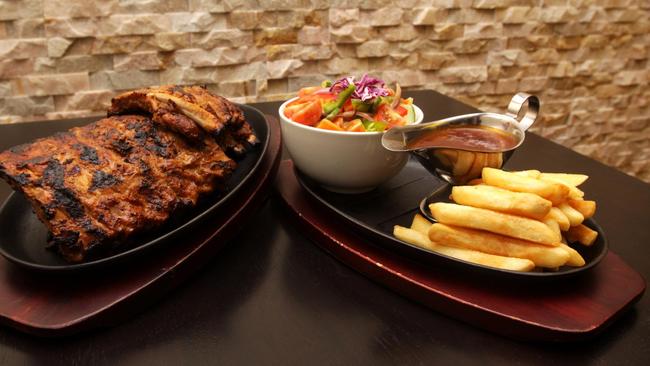 Squires Loft’s 1kg pork spare ribs with a side garden salad and chips with barbecue sauce. Picture: File.