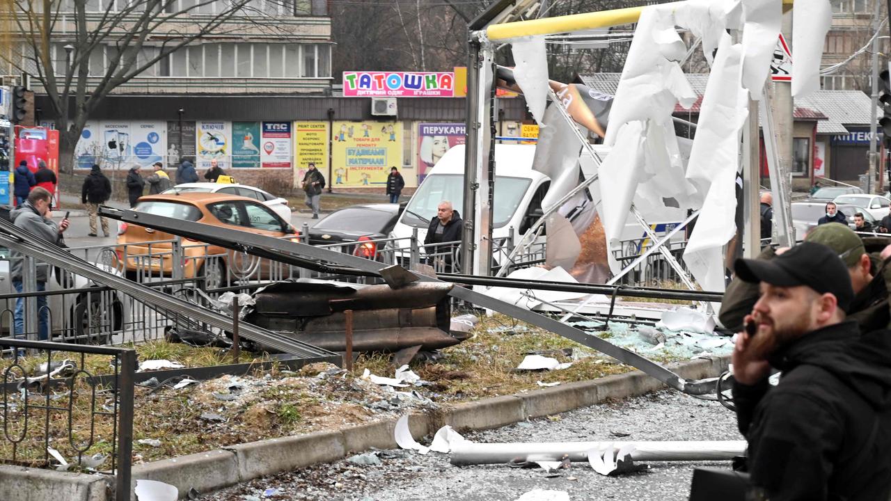 Police and security personnel inspect gather by the remains of a shell. Picture: Sergei Supinsky / AFP