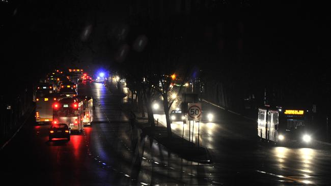 Motorists driving in total darkness through Adelaide’s CBD after a freak storm smashed critical infrastructure, plunging the entire state into darkness. Photo: AAP Image/David Mariuz