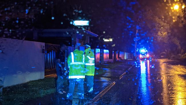 Ambulance officers speak with the man to calm him down.