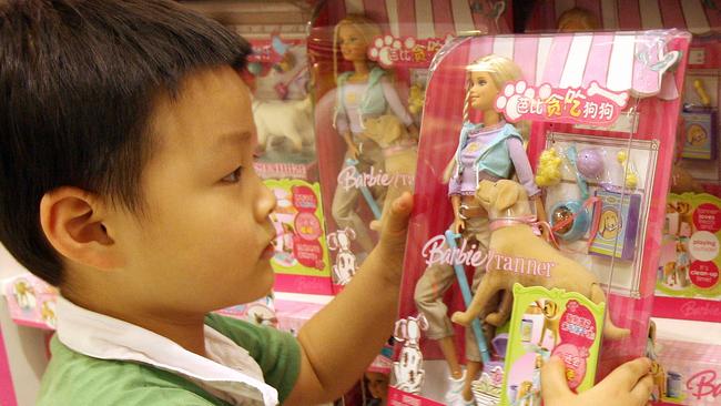 A Chinese boy holds a 'Barbie and Tanner' toy made by US toy giant Mattel, which is still for sale in China despite being recalled in the US, at a department store in Shanghai, 15/08/07. The US Consumer Product Safety Commission announced the recall of millions of toys manufactured by Mattel Inc., including the Barbie and Tanner play sets. According to the commission, the play sets' 