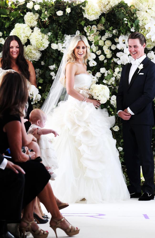 Roxy Jacenko and Oliver Curtis watching their baby daughter Pixie-Rose Curtis, left, during their wedding ceremony.