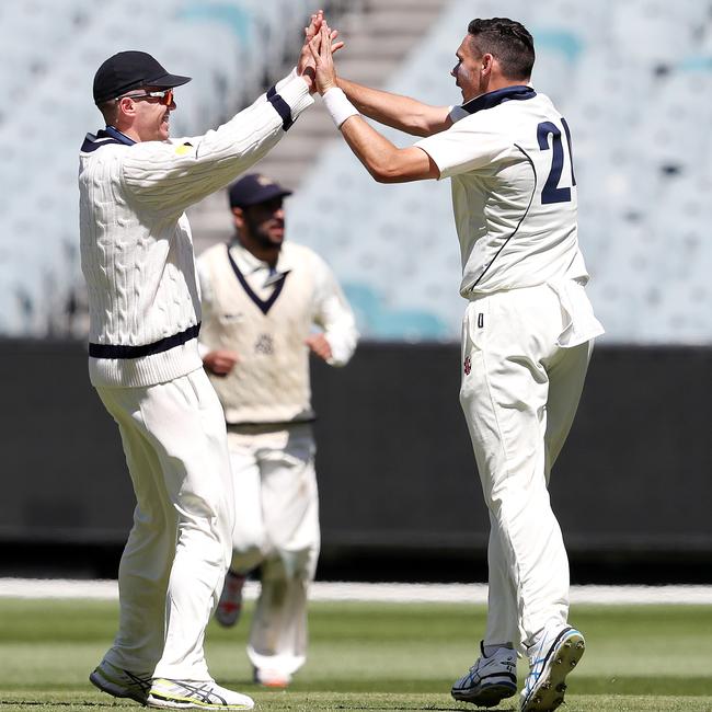 Scott Boland (right) celebrates a wicket with Peter Siddle (left) during a Sheffield Shield match. (AAP Image/George Salpigtidis)