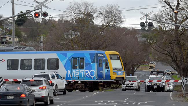 Before – a train crosses Maroondah Highway.